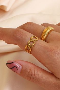 A woman wearing a gold heart ring. Gold Open Heart Ring For Valentine's Day, Gold Heart-shaped Open Ring For Valentine's Day, Adjustable Gold Heart Ring For Valentine's Day, Gold Open Ring Jewelry For Valentine's Day, Gold Plated Heart Shaped Ring, Gold Heart-shaped Metal Ring, Heart-shaped Gold Metal Ring, Gold Metal Heart Ring For Promise, Gold Heart Ring Suitable As A Gift