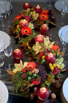 the table is set with candles and flowers