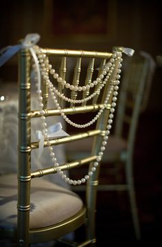 a gold chair with pearls on the back and seat is seen in this instagram photo