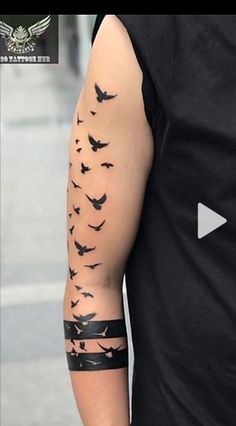 a man's arm with birds on it