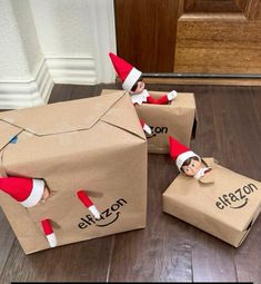 two cardboard boxes with an elf on them