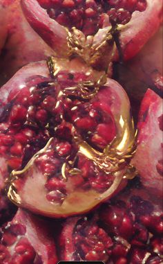 pomegranates with gold decorations on them are displayed in this close up photo