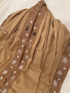 DHAAGE LONDON bring you this embroidered extremely soft Pashmina shawl which is perfect for layering in all weathers. Soft and fine with comfort feel giving that beautiful look and feel. It gives a great wearing experience.  Colour: Brown This luxurious Shawl has floral Design around the Border.  This shawl can be worn on special occasions as well as for casual wear. This is the perfect accessory to add to your wardrobe.  Luxury shawl to make you feel and look beautiful and elegant. Care and Mai Luxury Pashmina Dupatta, Traditional Wedding Scarves For Winter, Winter Shawl Dupatta With Embroidered Border, Wedding Shawl With Intricate Embroidery, Beige Pashmina Shawl With Traditional Drape Dupatta, Beige Pashmina Scarf For Wedding, Pashmina Scarf With Chikankari Embroidery, Embroidered Shawl For Eid, Beige Pashmina Shawl Dupatta For Wedding