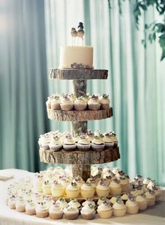 cupcakes are stacked on top of each other in the shape of a tree