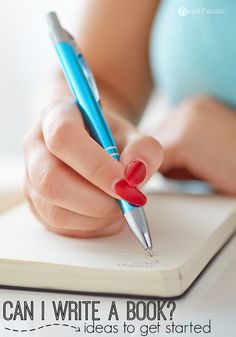 a woman is writing on a notebook with a blue and red pen in her hand