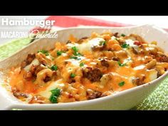 a casserole dish with meat and cheese in it on a green place mat