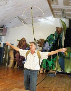 a man standing on top of a wooden floor holding a hula hoop in his hands