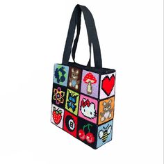 a handbag made out of squares with cats, hearts and other things on it