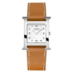 Stainless steel Hermes Heure H quartz watch featuring a white sunburst arabic dial with a high polished bezel and case. The watch case is 26mm and is attached to a gold Epsom calfskin strap. White Watches, Brown Watch, Hermes Watch, Movement Watches, White Dial Watch, Water Resistant Watch, Brown Watches, Brown Jewelry, Harry Winston