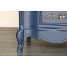 a blue dresser sitting on top of a hard wood floor