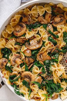 pasta with mushrooms and spinach in a pan