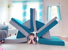 a young boy laying on the floor in front of an inflatable object