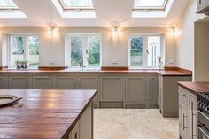 a large kitchen with an island and skylights in it's center window area