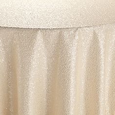 a white table cloth on top of a bed