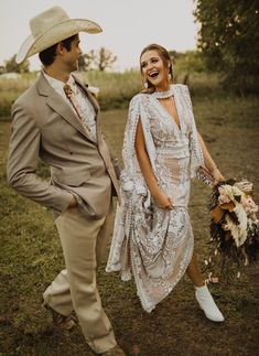 a man in a cowboy hat and dress walking next to a woman