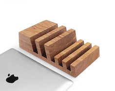 an apple laptop and wooden coasters are on display