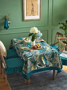 a dining room with green walls and blue chairs