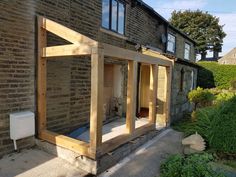 a house being built with wooden framing and windows