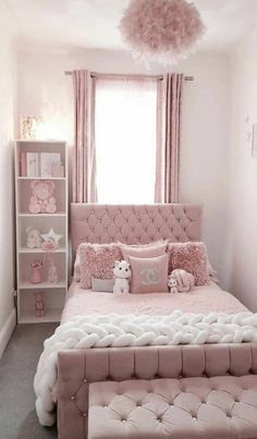 a bedroom with pink bedding, pillows and decor in shades of white and pink