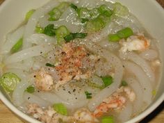 a white bowl filled with soup and vegetables