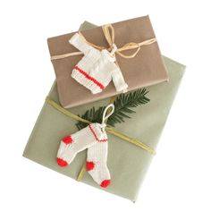 christmas presents wrapped in brown paper and tied with twine, including one sock ornament