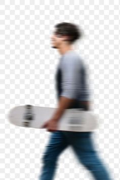 a man walking with a skateboard in his hand, while wearing jeans and a t - shirt