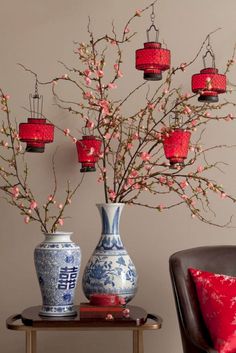 an image of a vases with flowers in them on a table next to a chair