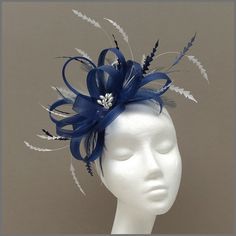 Light navy blue crinoline looped fascinator/headpiece. The detail of longer chevron cut feathers in white and navy adds height and creates a unique look. Made on a headband. This design is available in other colours on request. All of our designs can be made to order in a range of different colours or styles, see our colour chart: https://jacquivaledesigns.co.uk/pages/sinamay-colour-chart Please contact us if you would like a bespoke design to match your outfit. We make a range of ladies hats, f Wedding Hats For Guests Classy, Wedding Guest Fascinators, Navy Fascinator, Green Fascinator, Classy Hats, Blue White Weddings, Light Navy Blue, Blue Fascinator, Occasion Hats