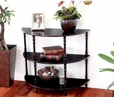 a corner shelf with books and plants on it