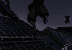 the silhouette of a person on top of a roof in front of a dark sky