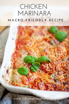 chicken marinara recipe in a white casserole dish with basil leaves on top