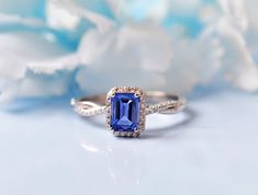 an engagement ring with a blue stone surrounded by diamonds