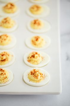 small deviled eggs with cinnamon sprinkles on a white tray