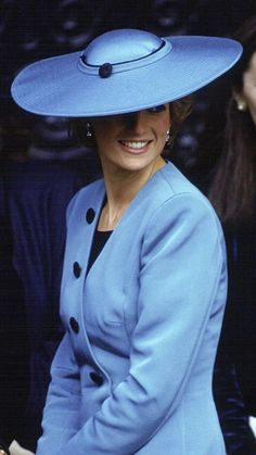 the woman is wearing a blue hat and smiling