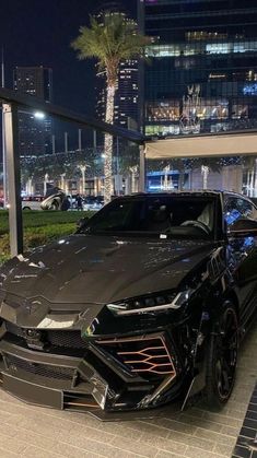 a black sports car parked in front of a building