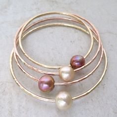 "Edison Pearl Bangle~ Elegant bangle with a beautiful Edison pearl, hammered and polished for that extra sparkle! Pearl approx. 10-11mm. Pearls vary in color Made with thick 12 g. your choice of 14k yellow or rose gold fill. SIZES~ extra small - 7\" small - 7.5\" Medium - 8\" Large - 8.5\" Extra large - 9\" For correct sizing measure the circumference of your hand around the largest part of your hand under your thumb and pinky joint with your thumb tucked in towards pinky finger, fingers out str Hand Forged Bangle For Wedding, Adjustable Hammered Wedding Bangle, Adjustable Hammered Bangle For Wedding, Hammered Bangle Bracelet For Anniversary, Pearl Bangles Gold, Surfer Girl Gifts, Tahitian Pearl Ring, Hammered Bracelet, Edison Pearls