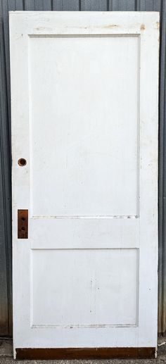 an old white door with a brown handle on the front and side panel is shown