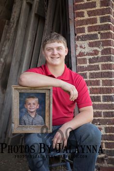 a young man holding up a photo frame