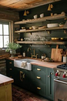 a kitchen with green cabinets and wooden shelves on the wall, along with an oven and dishwasher