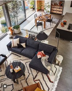 a living room filled with furniture and lots of windows