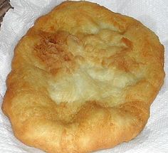 a piece of bread sitting on top of a white napkin