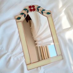 a mirror sitting on top of a white sheet