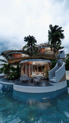 the house is surrounded by water and palm trees