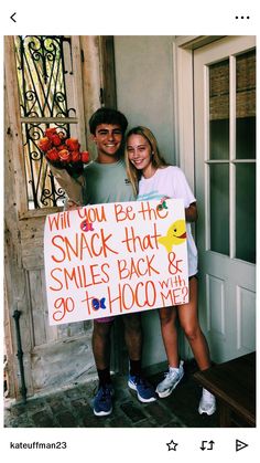 a man and woman standing next to each other holding a sign that says will you be the snack that smiles back & 90th hoo