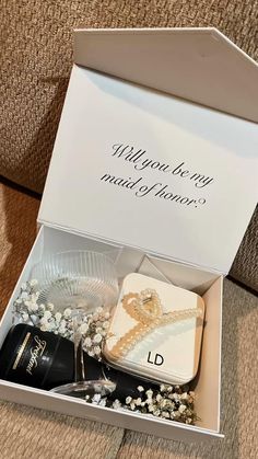 an open box with jewelry inside on the floor