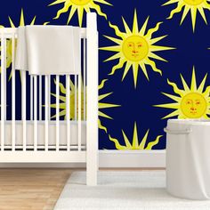 a baby crib in front of a wallpaper with the sun and moon on it