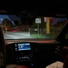 the interior of a car at night, with an electronic display on the dash board