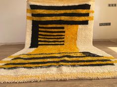 a large rug with black, yellow and white stripes