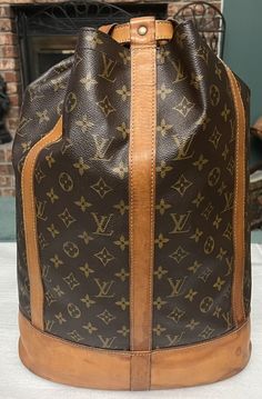 Louis Vuitton Monogram Randonnee GM Shoulder Bag Condition: Very Good Pre-owned Condition.  Clean interior with minimal signs of wear.  Brass hardware is clean with minimal wear.  Canvas is in good condition.  Vachetta leather (straps and trim) is in overall good condition with small signs of wear / very small watermarks (this is common for this style of bag).  Please see pics for exact condition.  All our pre-owned bags are professionally cleaned and checked for functionality before being offered for sale. Handbag only (no accessories) Color:  Monogram/Brown Serial number/Date Code: AS1905 Measurements (approximate): Width: 12.9 inch / 33 cm Height: 18.8 inch / 48 cm Depth: 7.08 inch / 18 cm Guaranteed 100% authentic...bag will ship through the eBay authenticity guarantee program and will Vintage Louis Vuitton Handbags, Moroccan Bags, Authentic Bags, Vintage Louis Vuitton, Brown Canvas, Small Signs, Vuitton Bag, Brass Hardware, Louis Vuitton Handbags