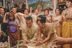 a group of people that are standing around a cake